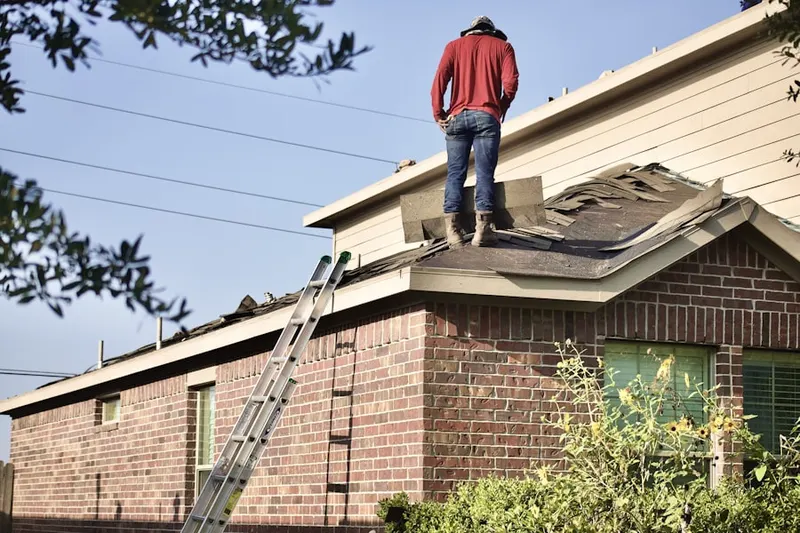 Professional roofer working on a residential roof in Arvada